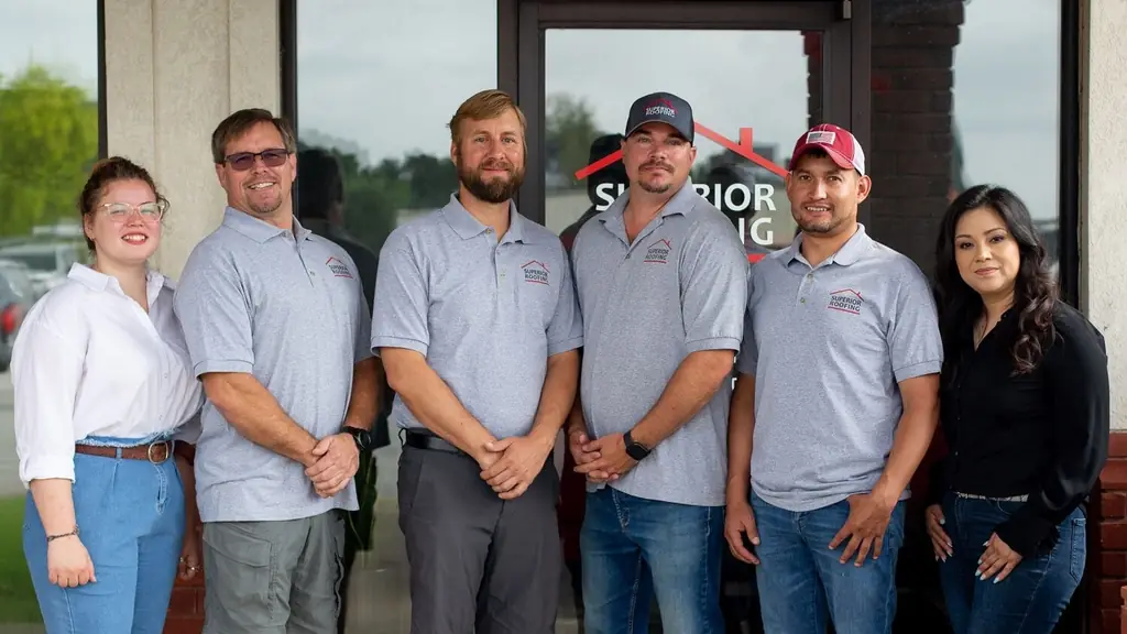 Six members of the Superior Roofing team outside the Springdale office door