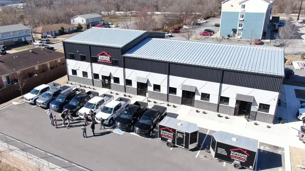 Aerial view of the Superior Roofing shop in Springdale with the fleet and two lettered trailers